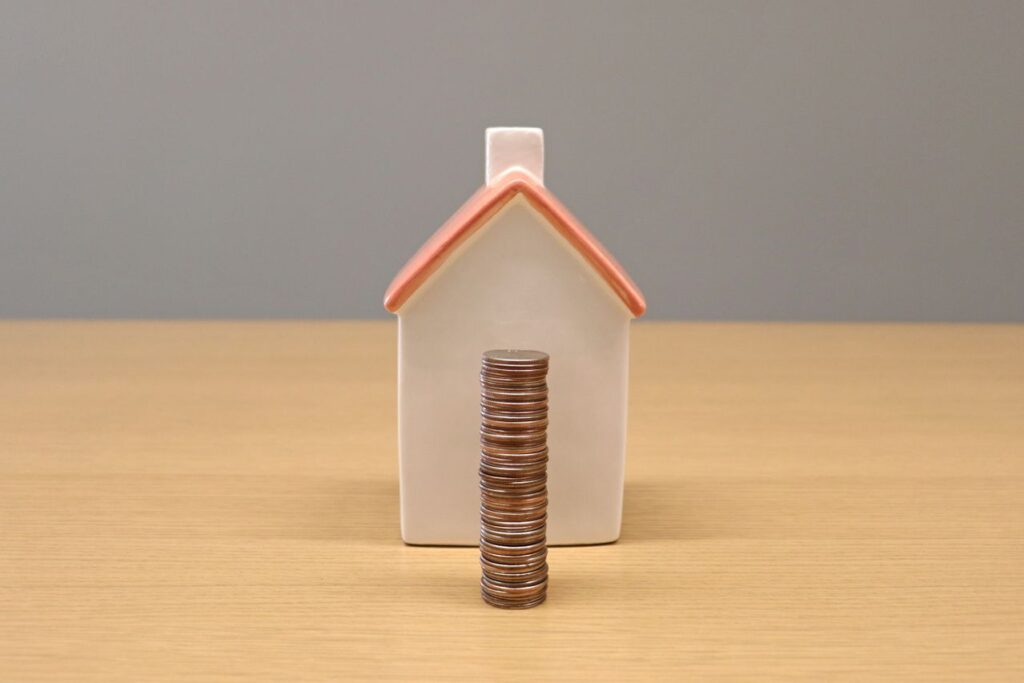 how to avoid PMI: small model house with a stack of coins