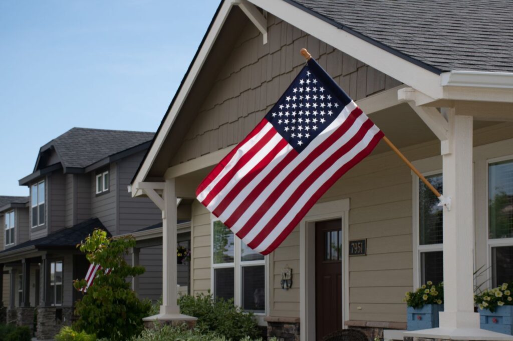 Suburban home with American flag that meets USDA loan requirements