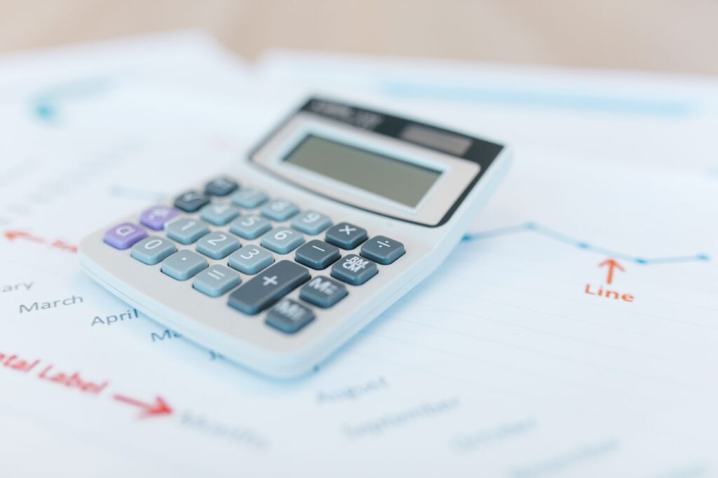 Mortgage calculator on top of financial papers with a chart