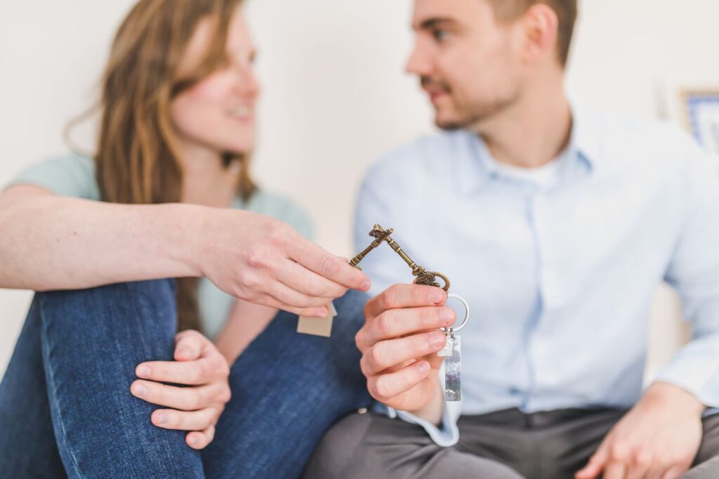 First-time homebuyer programs: couple sharing the keys to their new home